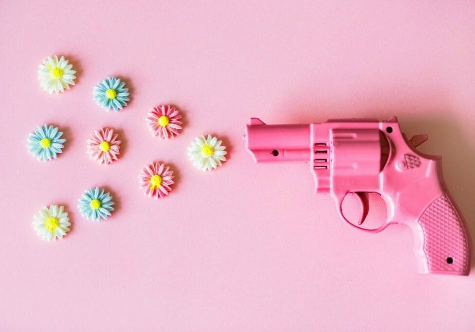 A plastic pink gun shooting out flowers