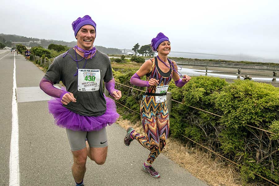 Couple in tutu and wild pants running